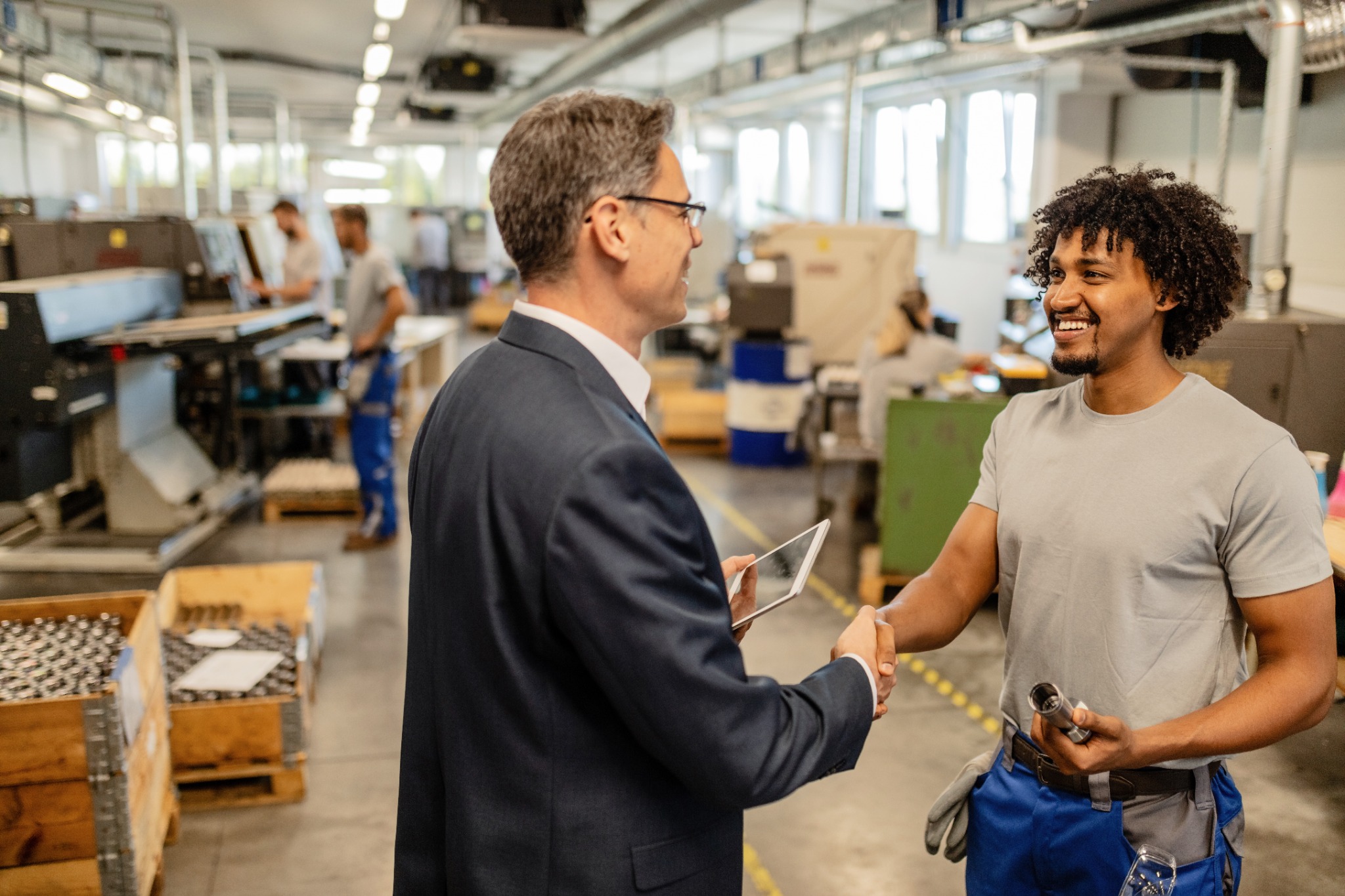 An engineer welcoming a skilled worker with a handshake